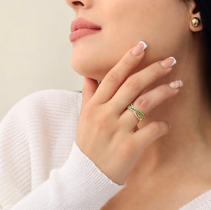 Intertwined ring with green and white zircons